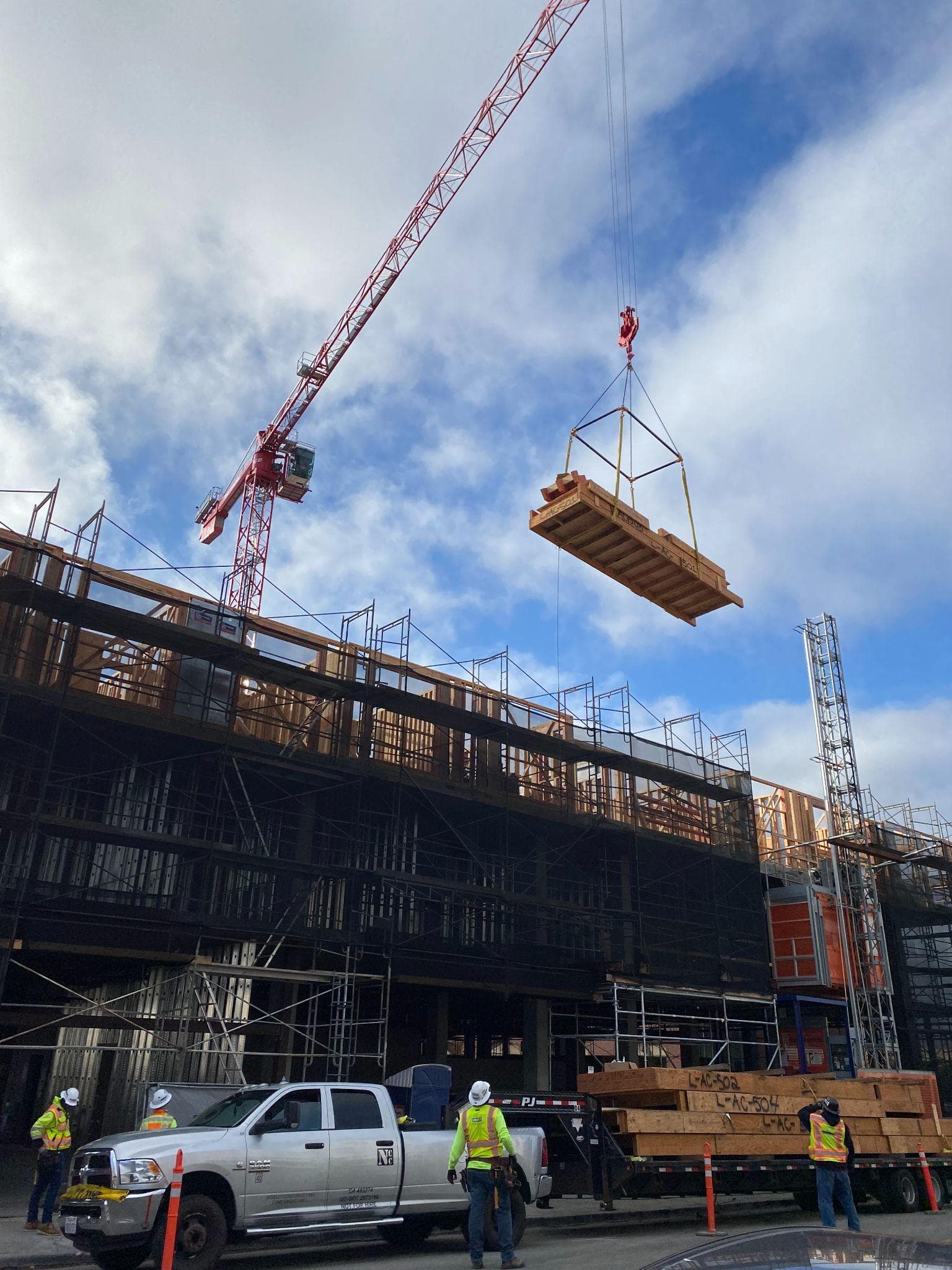 Overhead view of crane setting floor panels