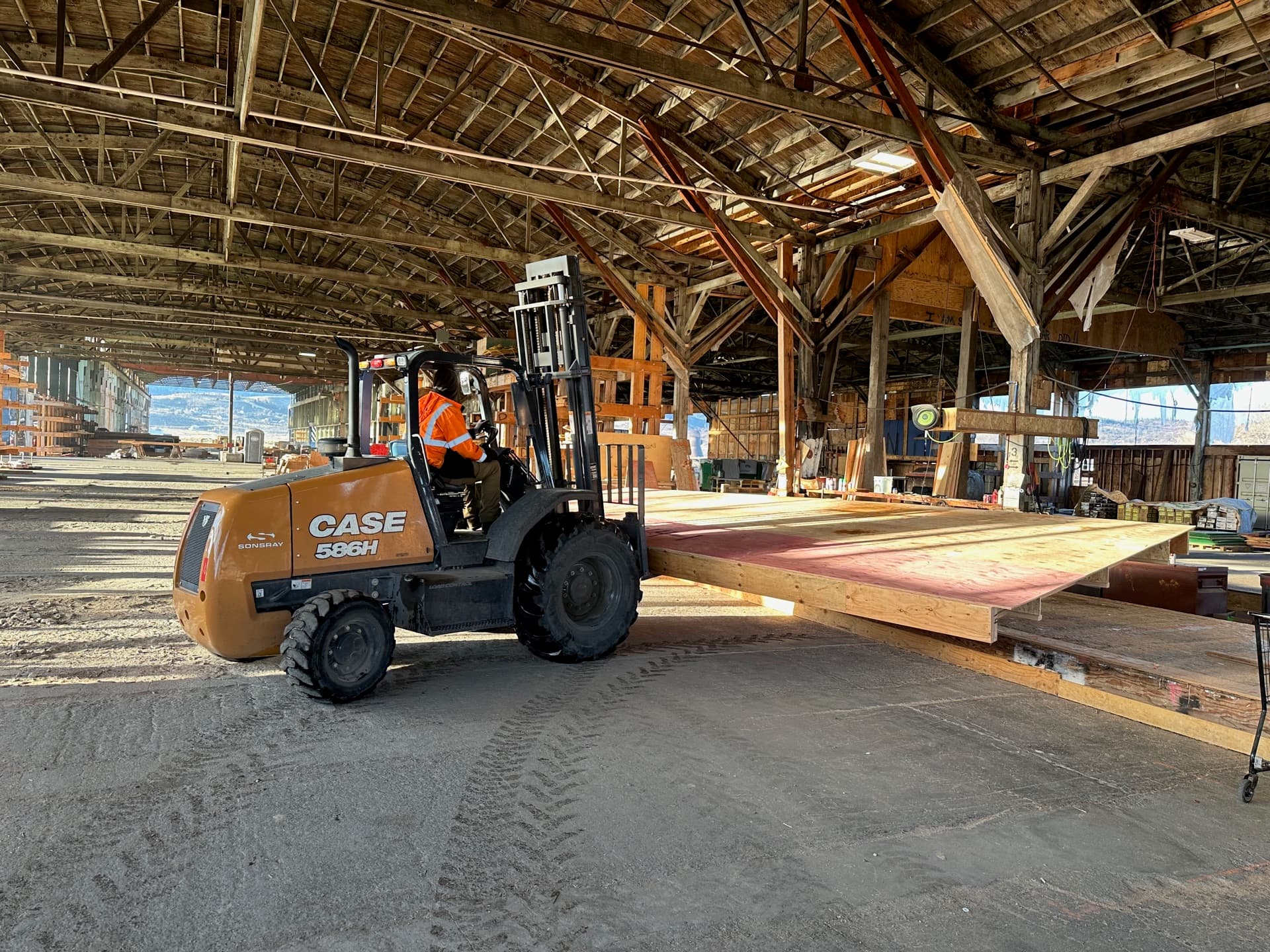Forklift moving a floor cassette panel inside factory