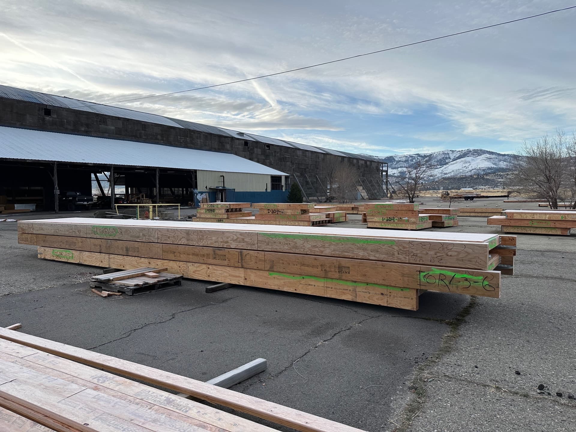 Stacked panels in yard with snow-capped mountains