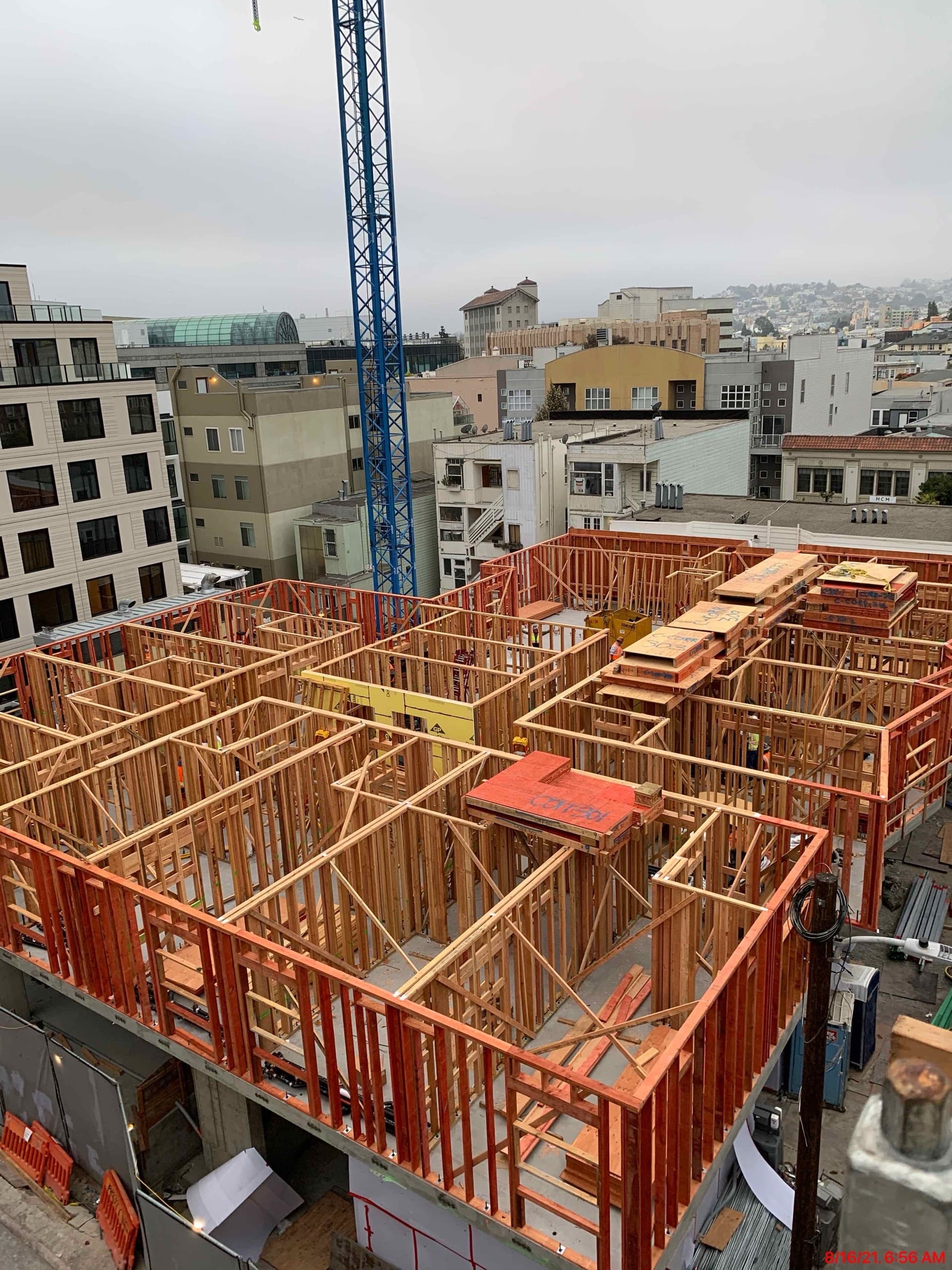 Elevated view of framed floor with crane and San Francisco buildings