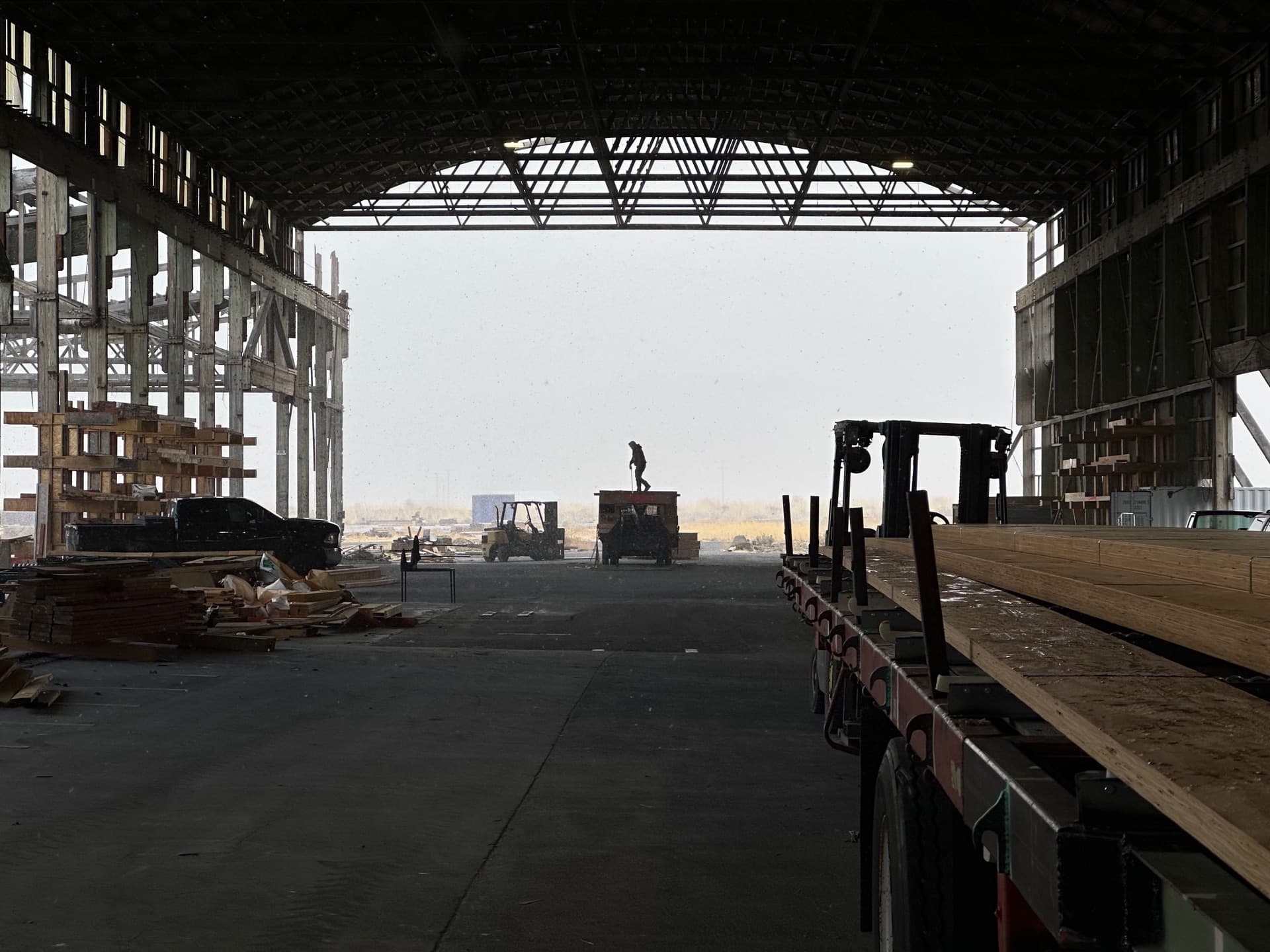 Factory interior silhouette with worker and equipment