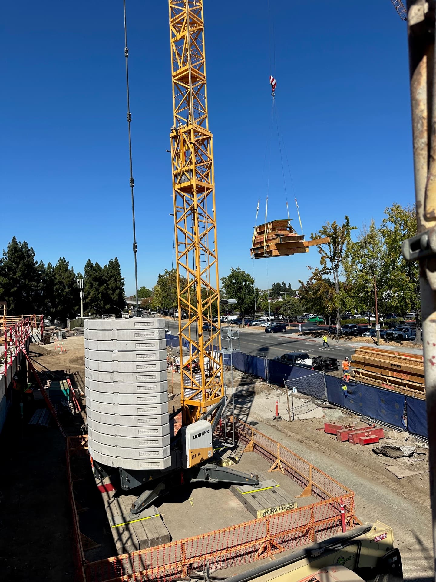 Tower crane lifting cassette panels at jobsite