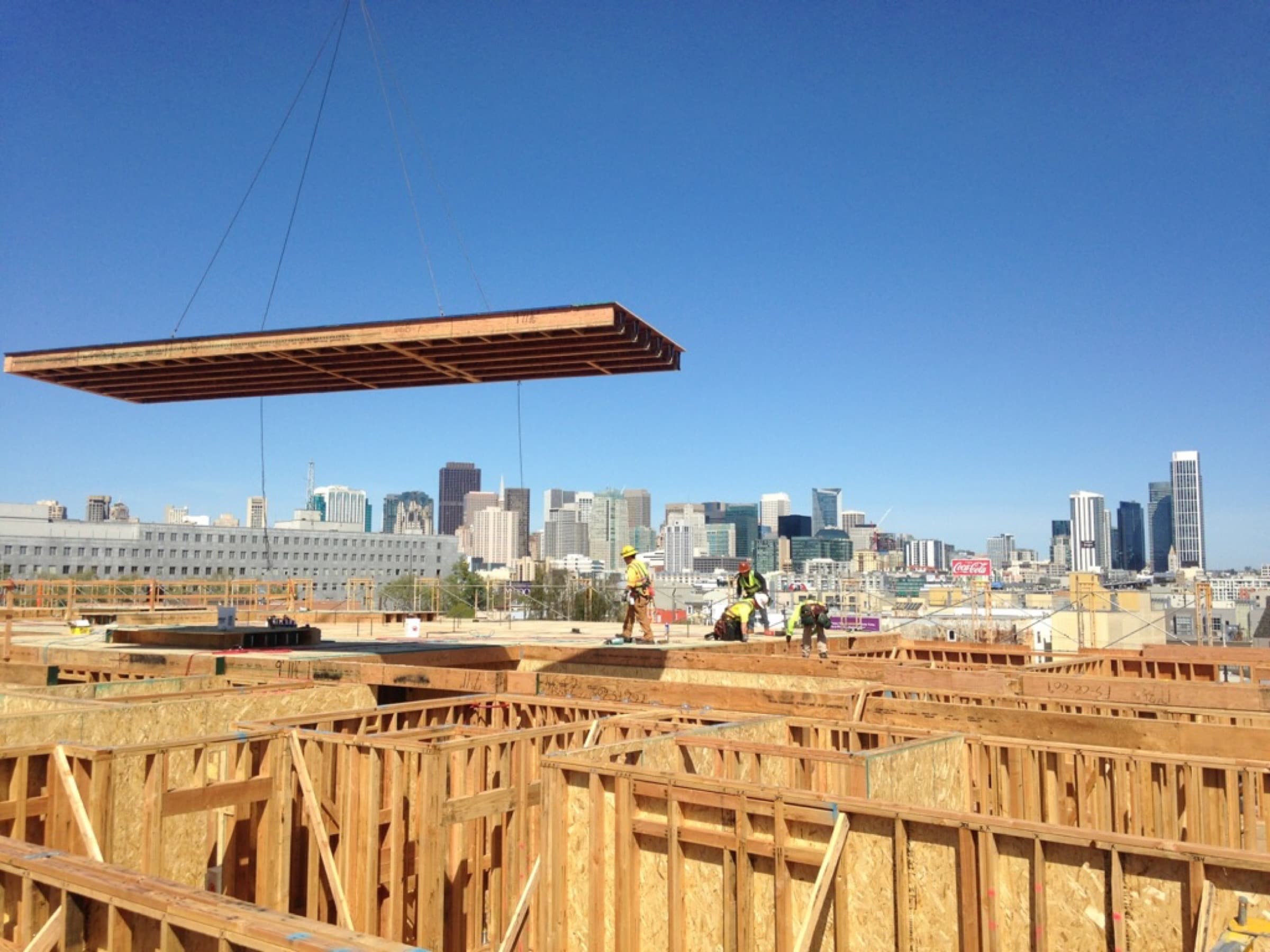 Floor cassette suspended mid-air with San Francisco skyline behind at 801 Brannan