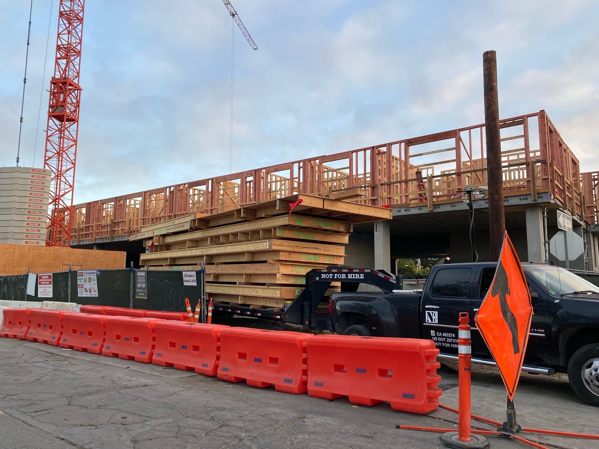 Coliseum Place construction with NCC panels and red crane